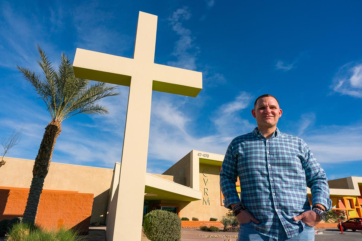Man standing in front of CVRM facilities